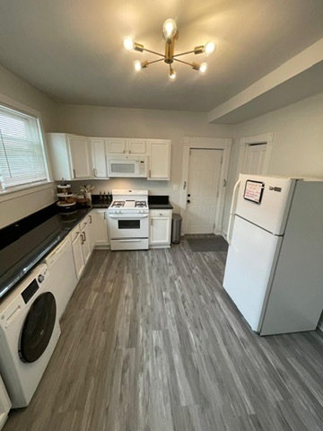 3625 West Shakespeare Avenue, Unit 3 Chicago, IL 60647 - Photo 3 of 21 a kitchen with kitchen island wooden floors appliances and cabinets