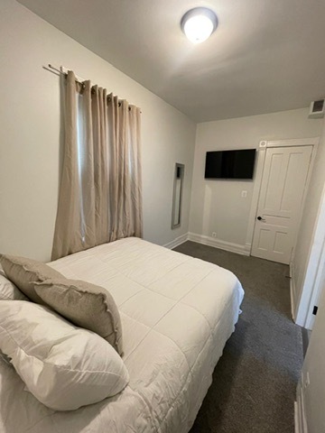 3625 West Shakespeare Avenue, Unit 3 Chicago, IL 60647 - Photo 10 of 21 a bedroom with a bed and a flat tv screen