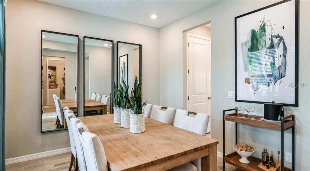 5241 Bowspirit Way St. Cloud, FL 34771 - Photo 6 of 17 a view of a dining room with furniture and wooden floor