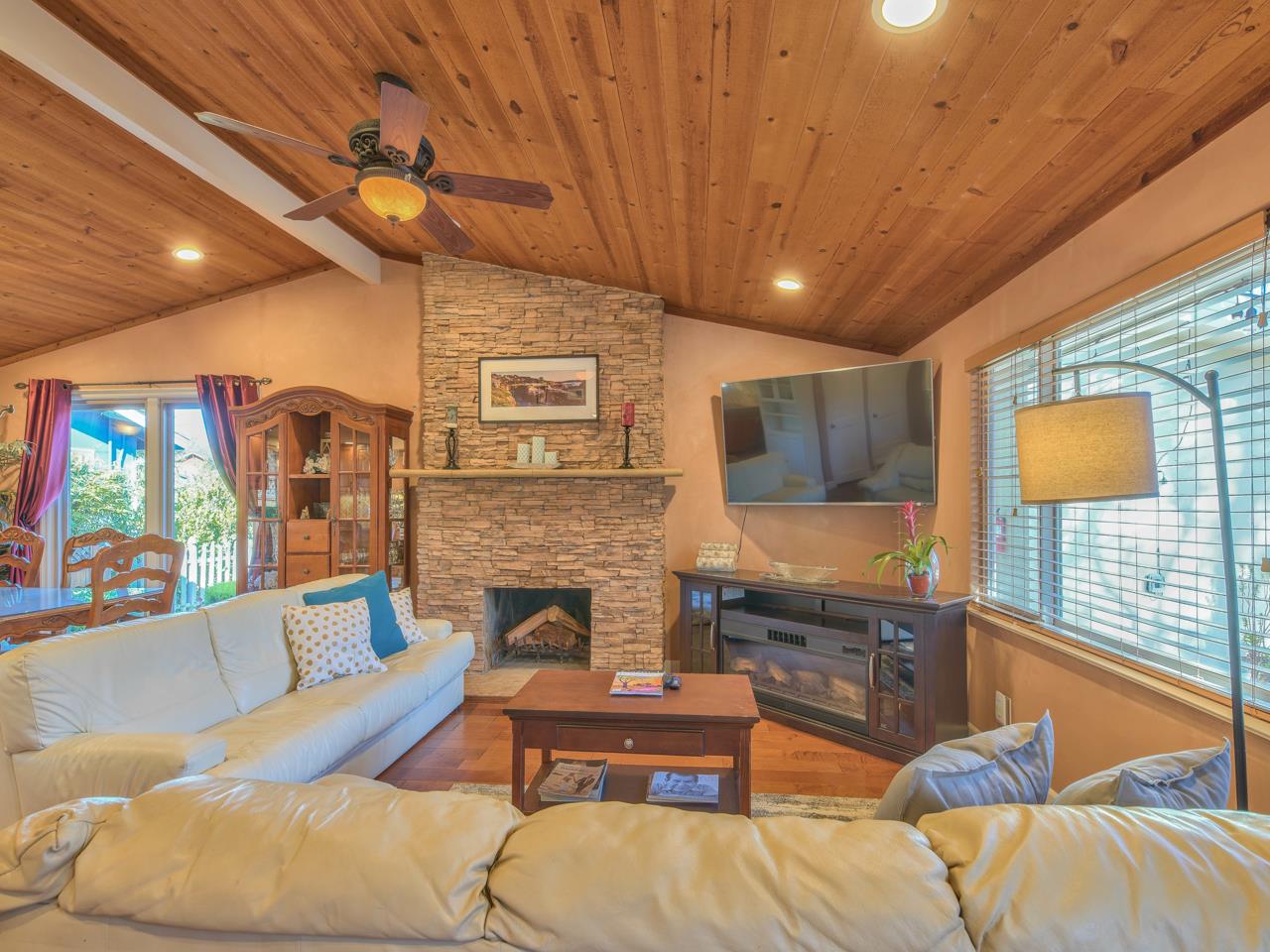 26464 Mission Fields Road Carmel, CA 93923 - Photo 12 of 35 a living room with furniture a flat screen tv and a fireplace