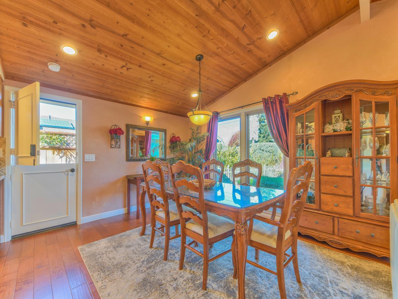26464 Mission Fields Road Carmel, CA 93923 - Photo 14 of 35 a view of a dining room with furniture window and wooden floor
