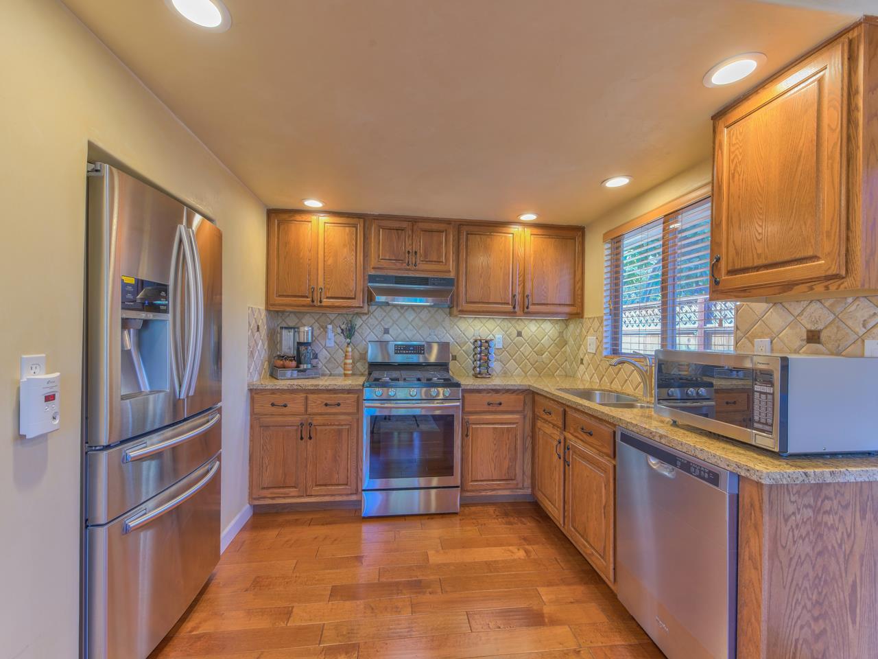 26464 Mission Fields Road Carmel, CA 93923 - Photo 18 of 35 a kitchen with stainless steel appliances granite countertop a refrigerator sink and wooden cabinets