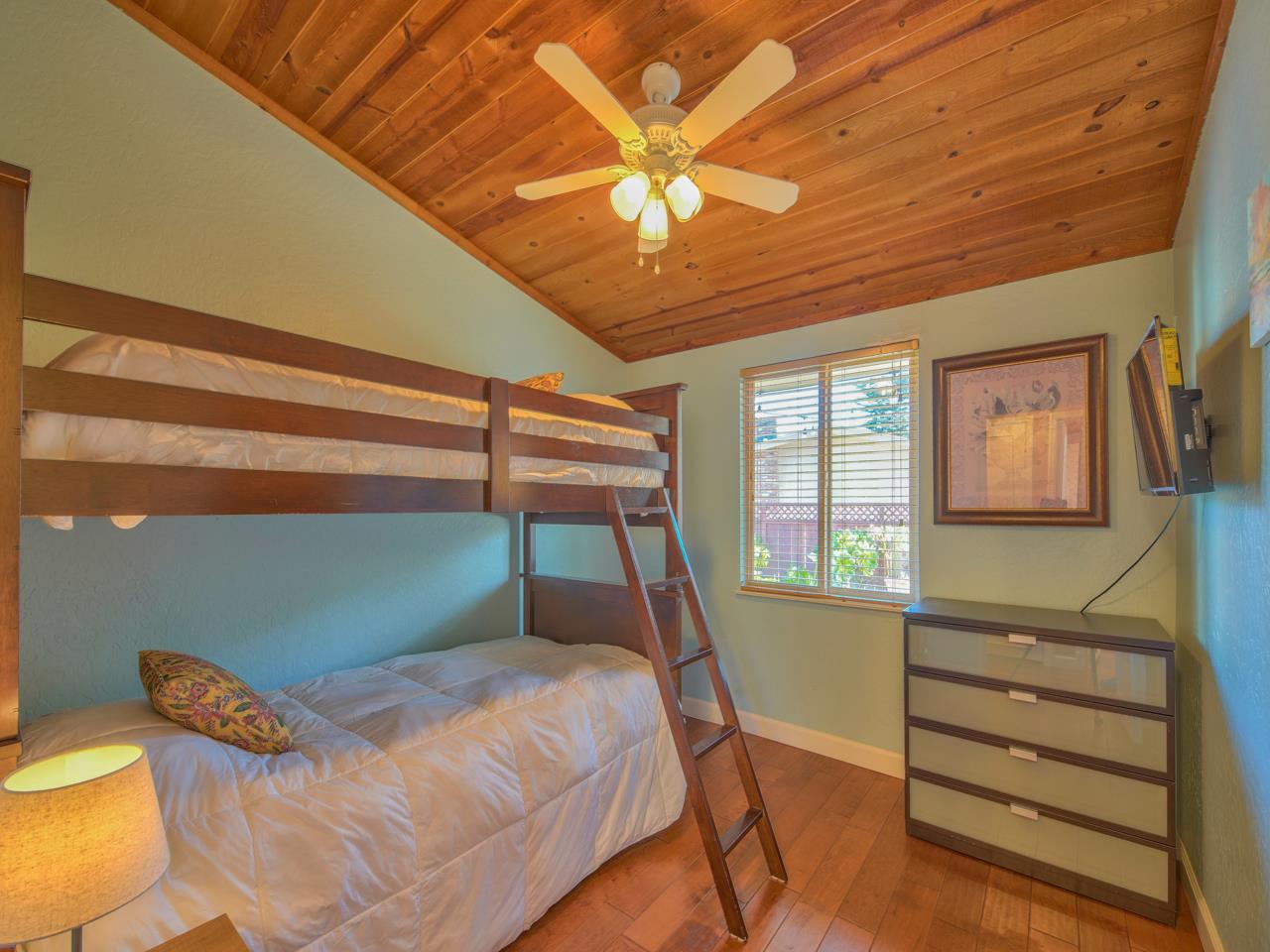 26464 Mission Fields Road Carmel, CA 93923 - Photo 27 of 35 a bedroom with a bed and a chandelier