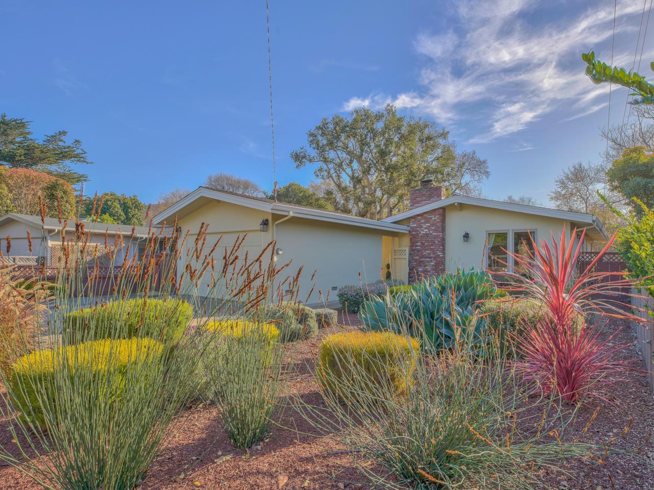 26464 Mission Fields Road Carmel, CA 93923 - Photo 3 of 35 a view of a house with a small yard and plants