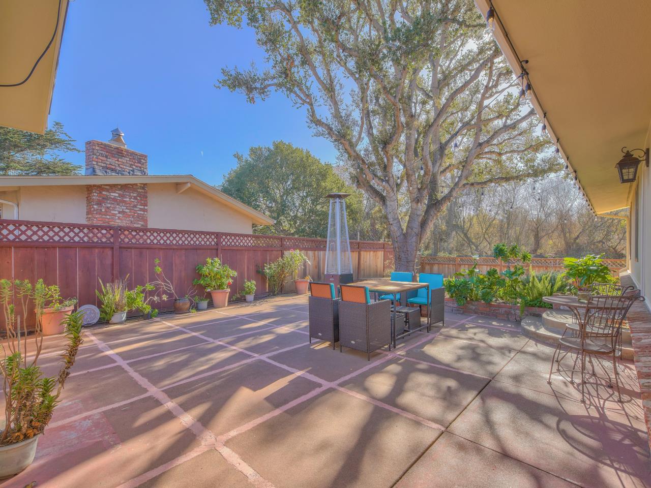 26464 Mission Fields Road Carmel, CA 93923 - Photo 5 of 35 a patio with a table and chairs and potted plants