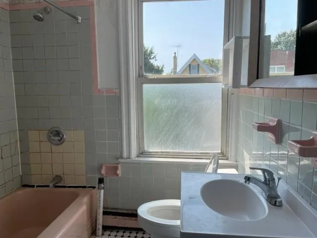 a bathroom with a sink a toilet and bathtub