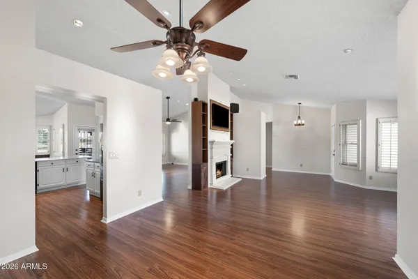a kitchen with stainless steel appliances kitchen island granite countertop a sink refrigerator and cabinets