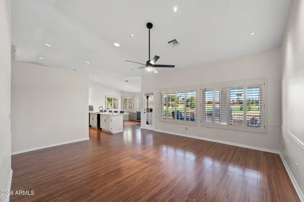 a view of a kitchen with wooden floor and windows