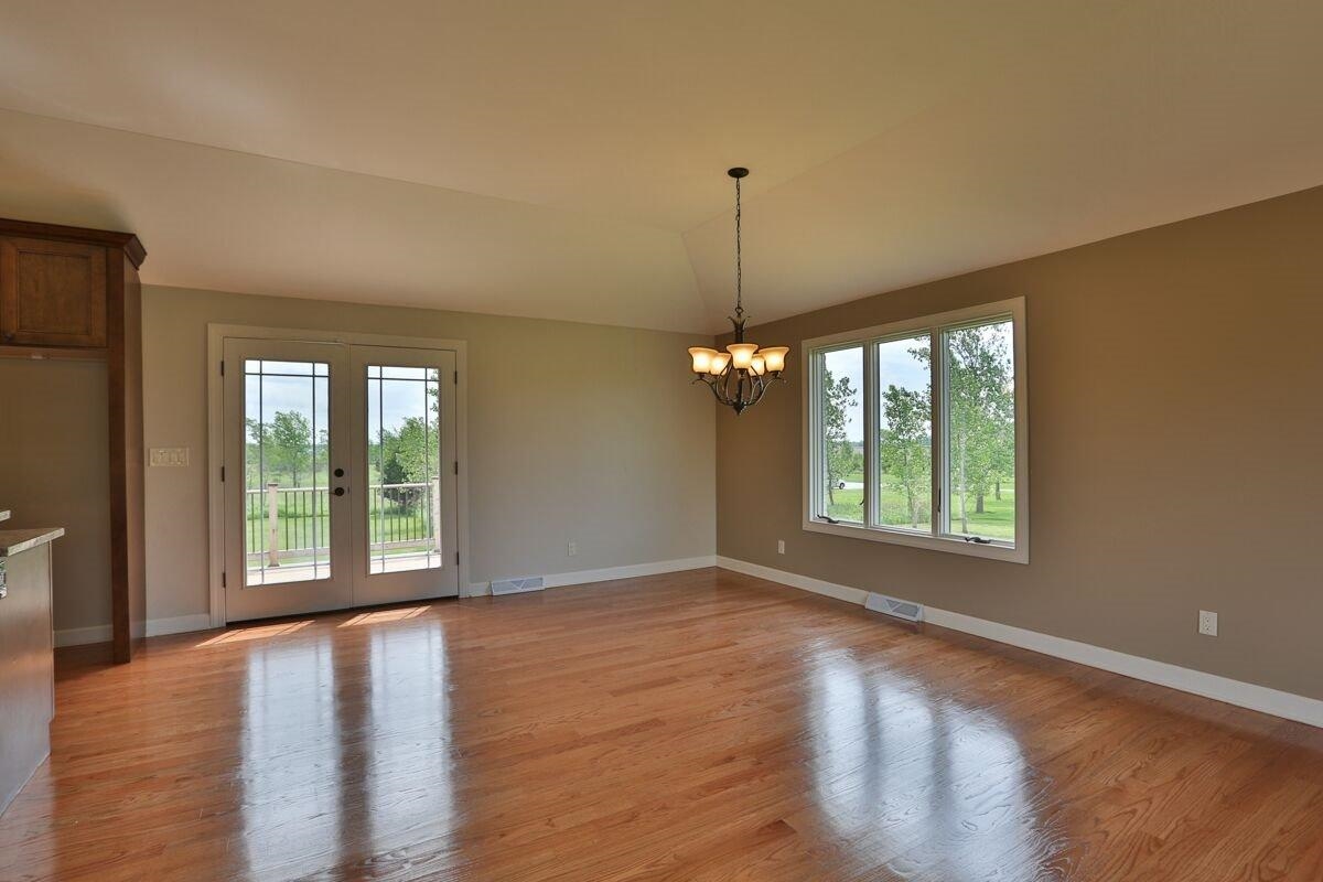 12665 Stateline Road Cedar Lake, IN 46303 - Photo 5 of 10 a view of an empty room with a window and wooden floor