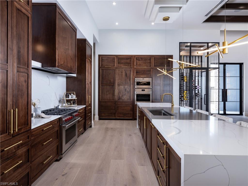 18300 Blue Eye Loop Fort Myers, FL 33913 - Photo 16 of 49 a kitchen with stainless steel appliances granite countertop a stove a sink and a refrigerator