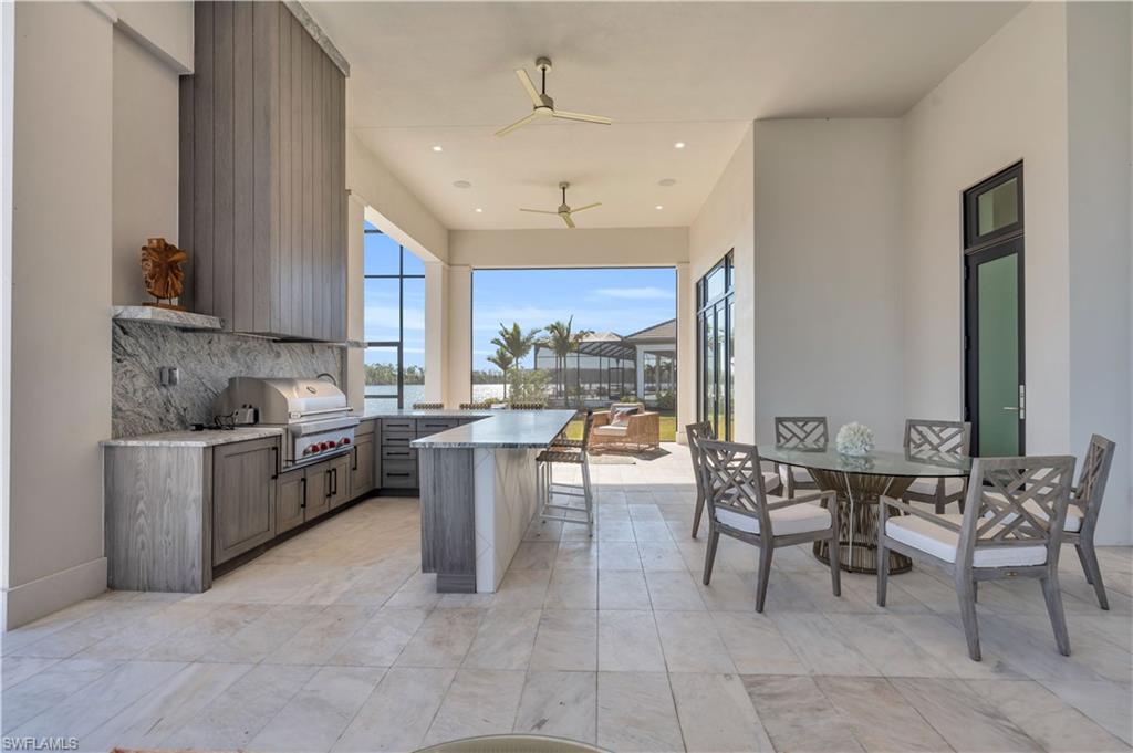 18300 Blue Eye Loop Fort Myers, FL 33913 - Photo 33 of 49 a kitchen with sink cabinets and dining table