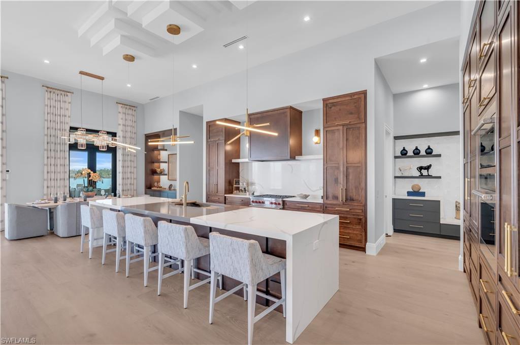 18300 Blue Eye Loop Fort Myers, FL 33913 - Photo 6 of 49 a large kitchen with a table and chairs in it