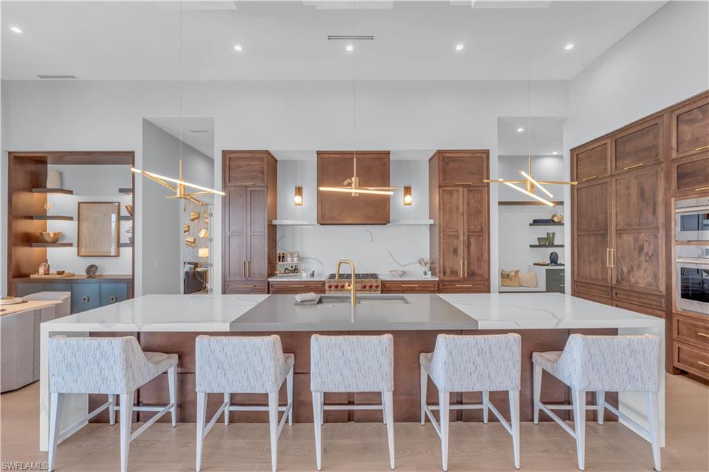 18300 Blue Eye Loop Fort Myers, FL 33913 - Photo 10 of 49 a dining table with chairs and kitchen island
