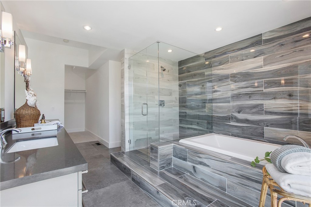 773 Barracuda Way Laguna Beach, CA 92651 - Photo 17 of 38 a bathroom with a granite countertop sink a toilet and shower
