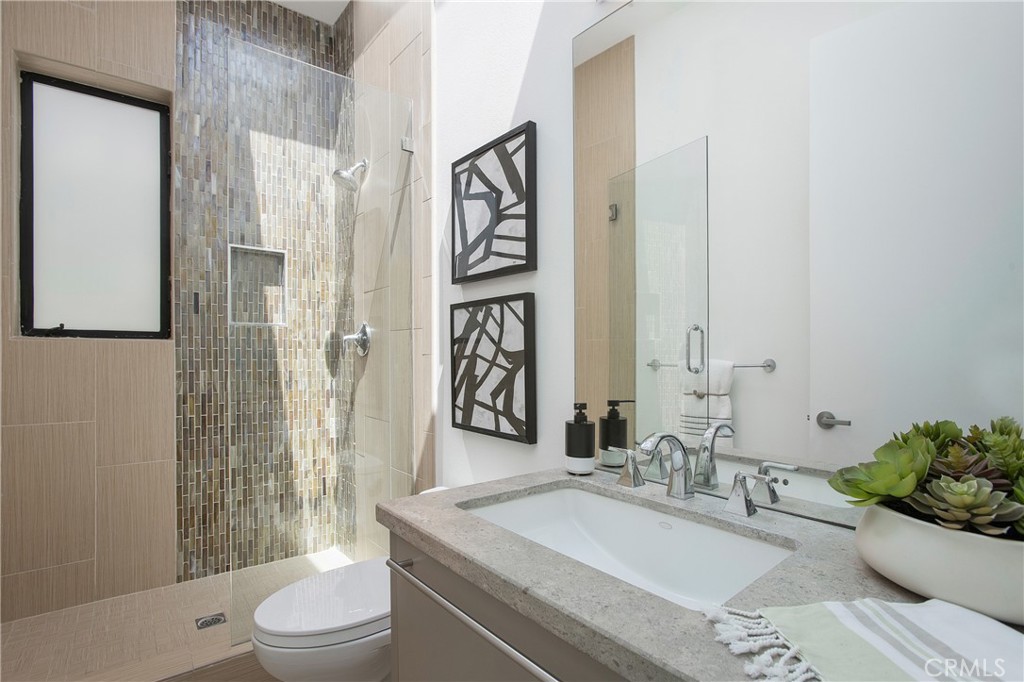 773 Barracuda Way Laguna Beach, CA 92651 - Photo 20 of 38 a bathroom with a granite countertop sink and a mirror