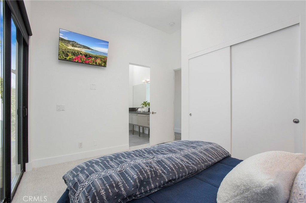 773 Barracuda Way Laguna Beach, CA 92651 - Photo 22 of 38 a bedroom with a bed and a wall painting