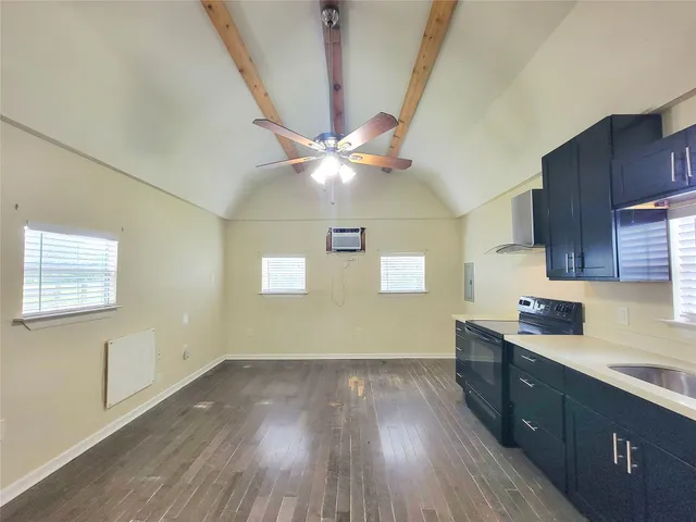 a kitchen with wooden floors and a sink