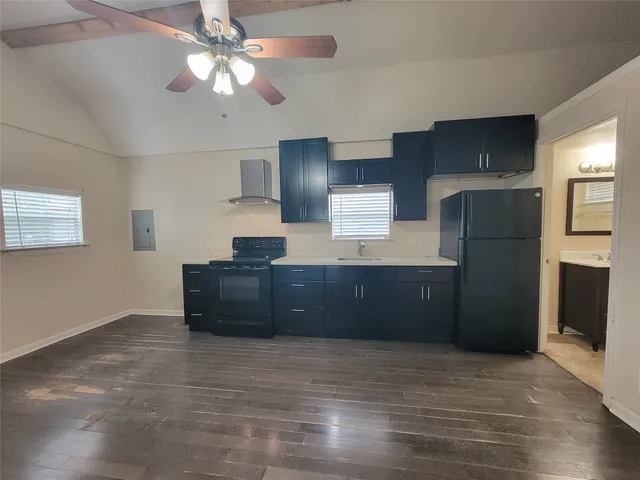 a kitchen with a refrigerator and a sink