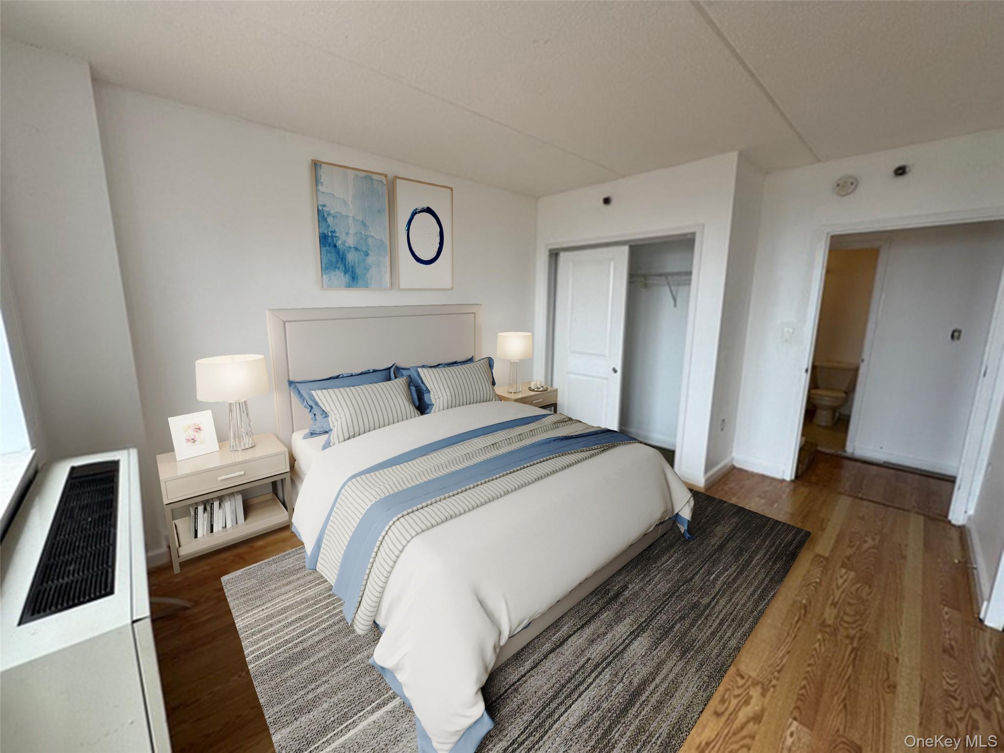 116-12 Ocean Promenade, Unit 706 Queens, NY 11694 - Photo 4 of 10 a bedroom with a bed and wooden floor