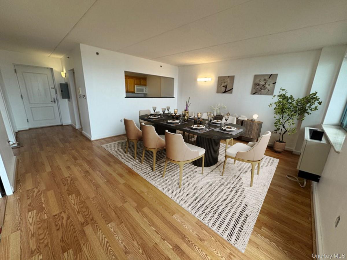 116-12 Ocean Promenade, Unit 706 Queens, NY 11694 - Photo 5 of 10 a living room with furniture and a flat screen tv