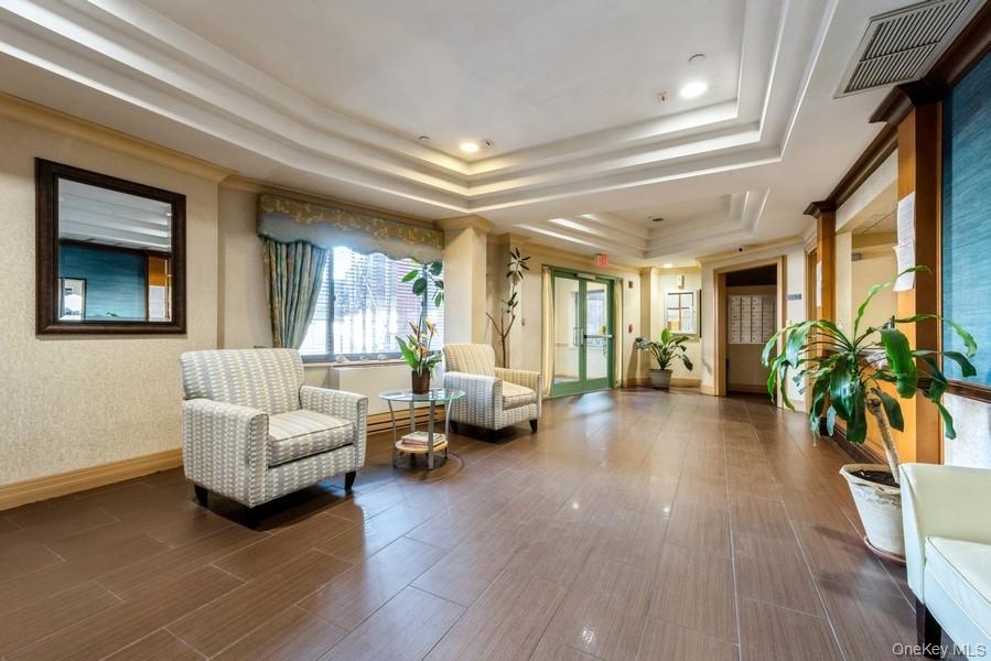 116-12 Ocean Promenade, Unit 706 Queens, NY 11694 - Photo 7 of 10 a living room with furniture and a large window