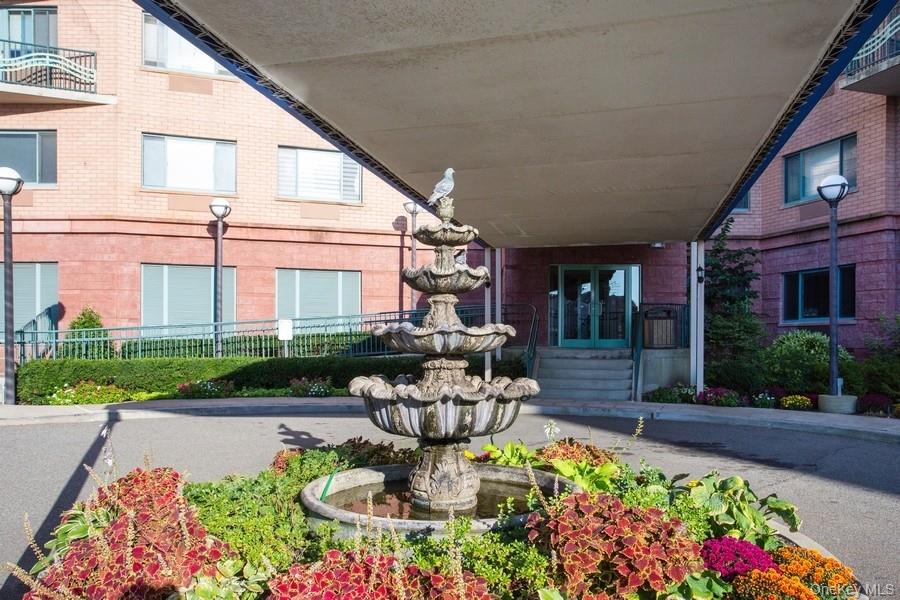 116-12 Ocean Promenade, Unit 706 Queens, NY 11694 - Photo 9 of 10 a front view of a house with a fountain bath tub and a fire pit