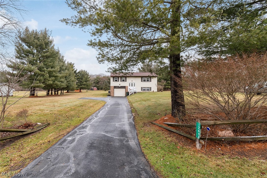 12640 Doylestown Road Rittman, OH 44270 - Photo 1 of 35 View of front of property featuring a front yard and a garage