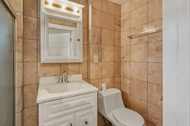 a walk in closet with a black white checkered floor next to a window