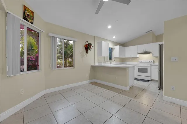 a kitchen with stainless steel appliances granite countertop a refrigerator sink and cabinets