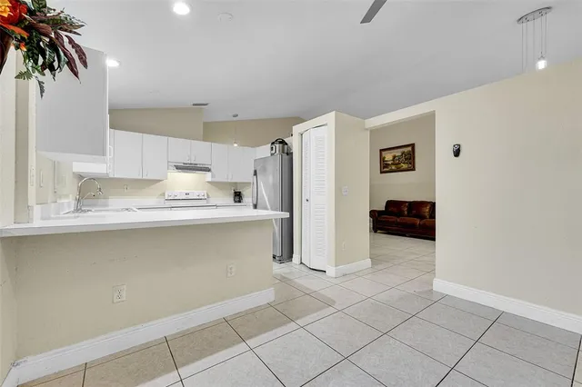 a kitchen with stainless steel appliances a refrigerator and a sink