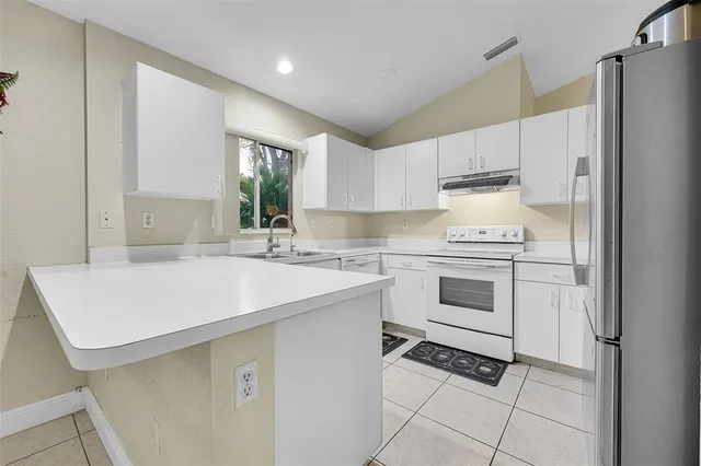 a kitchen with a sink stove and refrigerator