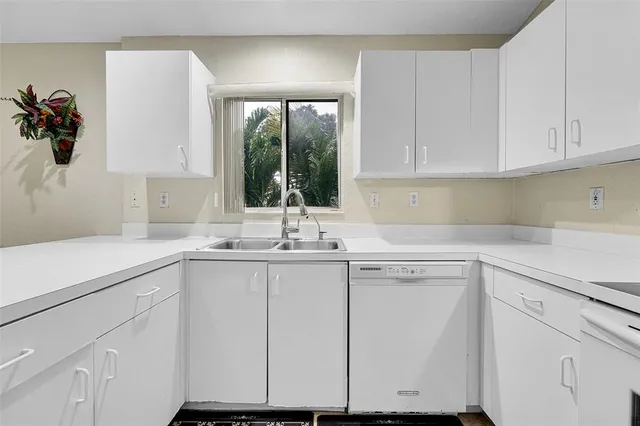 a kitchen with appliances cabinets and a sink