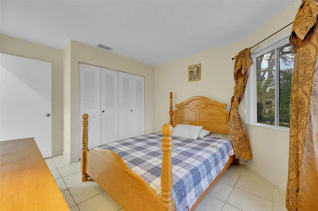 a bedroom with a bed and window