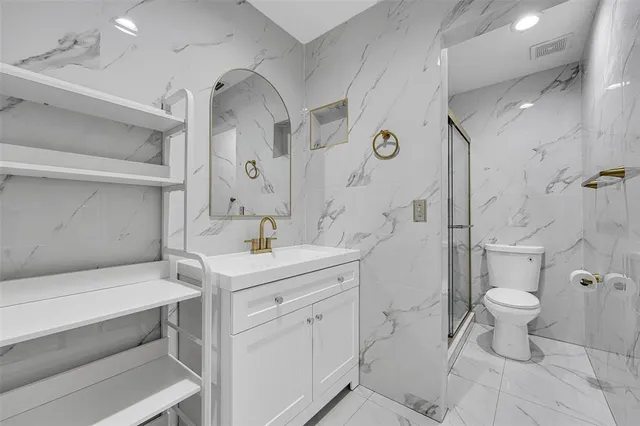 a bathroom with a sink toilet and shower