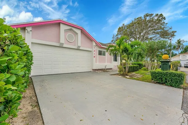 a view of a house with a yard and garage