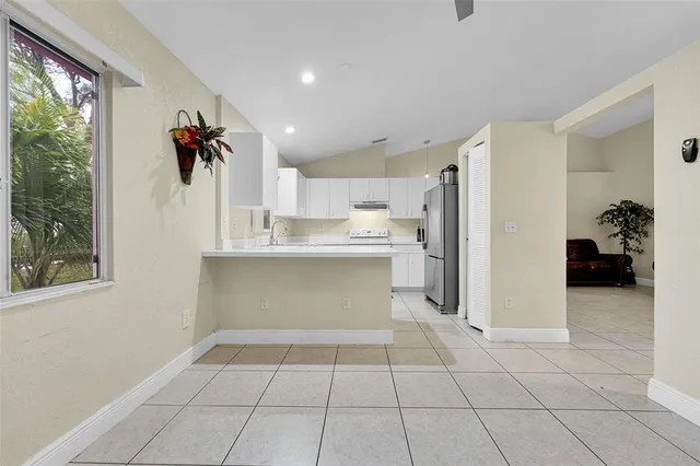 a kitchen with a refrigerator and a sink