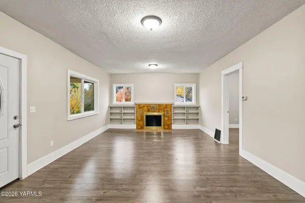 a large kitchen with stainless steel appliances granite countertop a lot of counter space and wooden floor