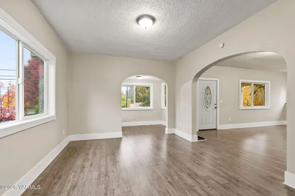 a view of a hallway with wooden floor