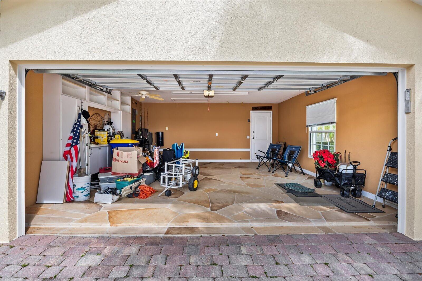 918 Southwest Balmoral Trace Stuart, FL 34997 - Photo 26 of 45 Garage with storage and stamped concrete