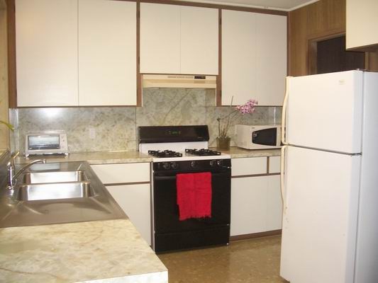 5200 Sokei Road Kapaa, HI 96746 - Photo 2 of 22 a kitchen with stainless steel appliances granite countertop a refrigerator a stove a sink and a microwave