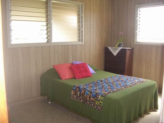 5200 Sokei Road Kapaa, HI 96746 - Photo 7 of 22 a bedroom with a bed and a window