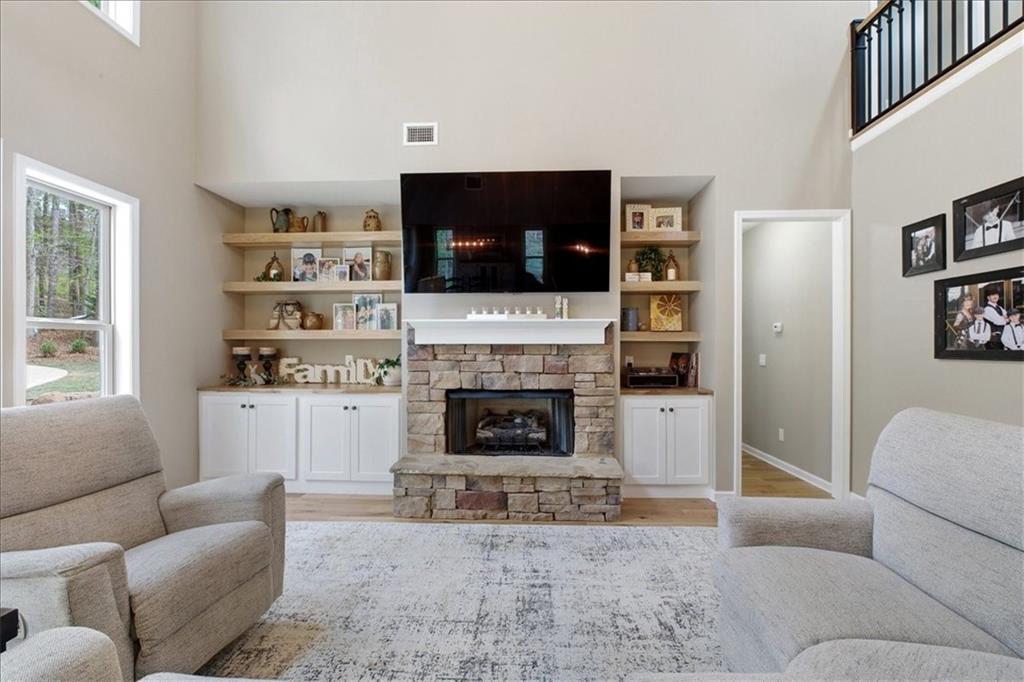 19 Pinoak Trail Cartersville, GA 30121 - Photo 21 of 55 a living room with furniture a flat screen tv and a fireplace