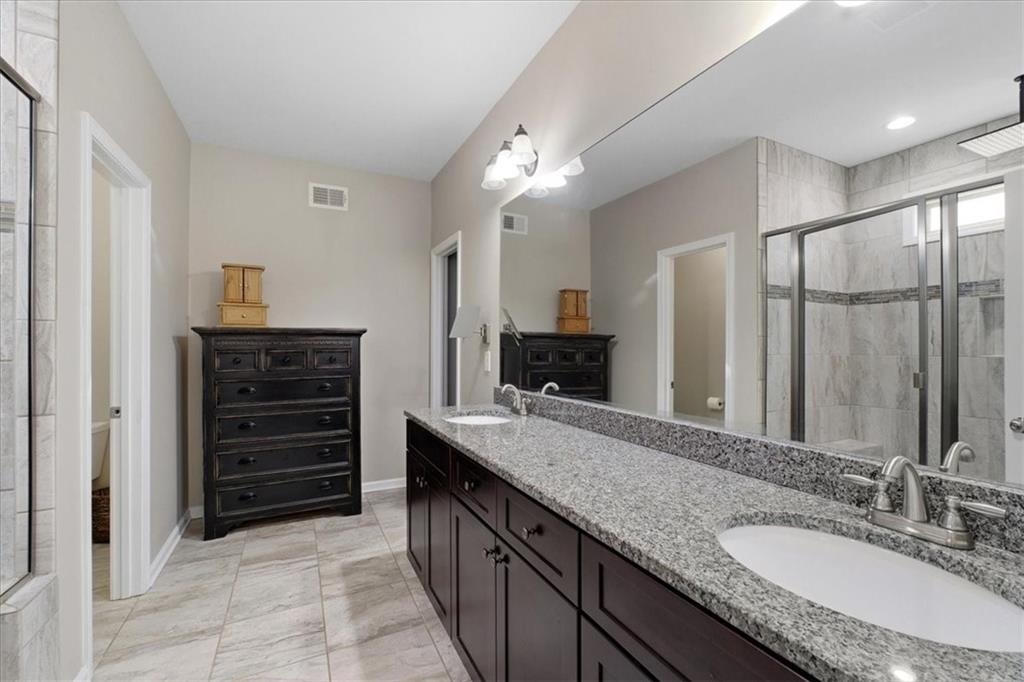 19 Pinoak Trail Cartersville, GA 30121 - Photo 24 of 55 a bathroom with a granite countertop sink double vanity and a mirror