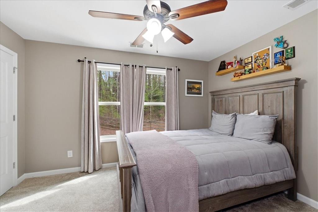 19 Pinoak Trail Cartersville, GA 30121 - Photo 31 of 55 a bedroom with a large bed and a chandelier