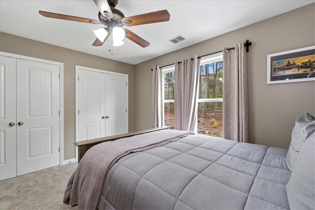 19 Pinoak Trail Cartersville, GA 30121 - Photo 32 of 55 a bedroom with a large bed and a ceiling fan