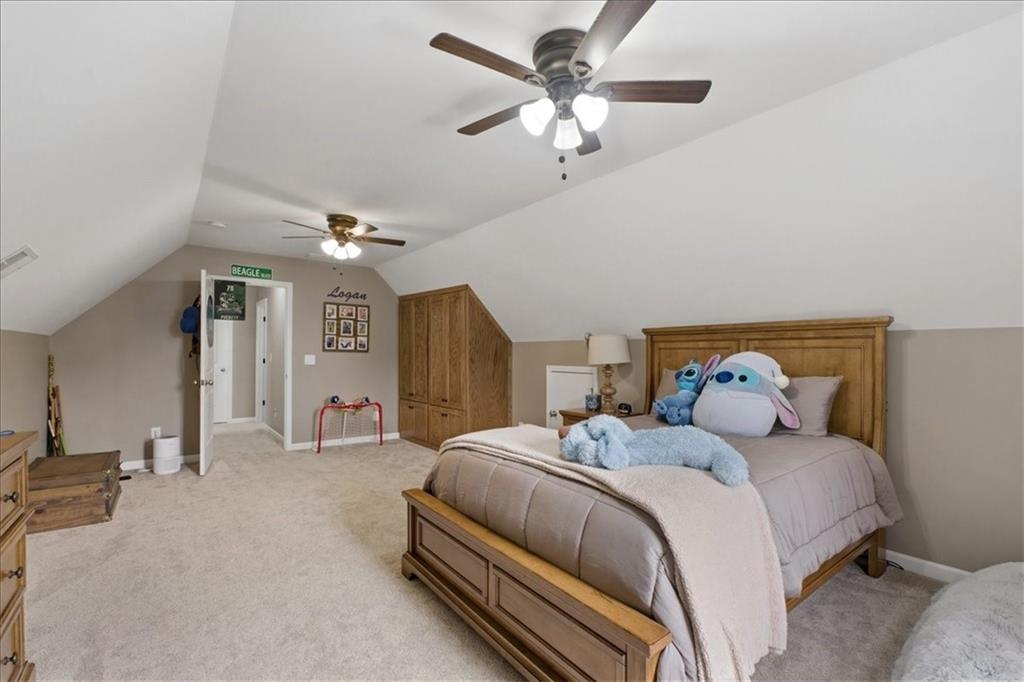 19 Pinoak Trail Cartersville, GA 30121 - Photo 35 of 55 a bedroom with a large bed and a chandelier