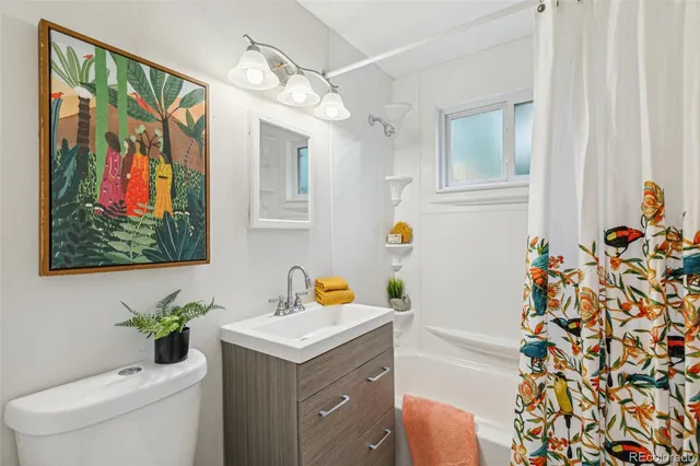 a bathroom with a sink mirror vanity and toilet