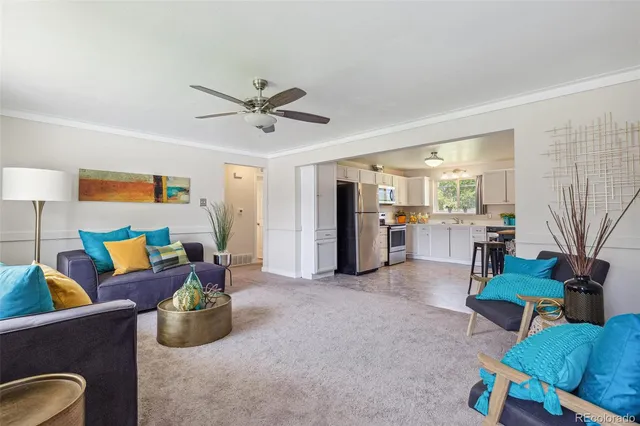 a living room with furniture and kitchen view
