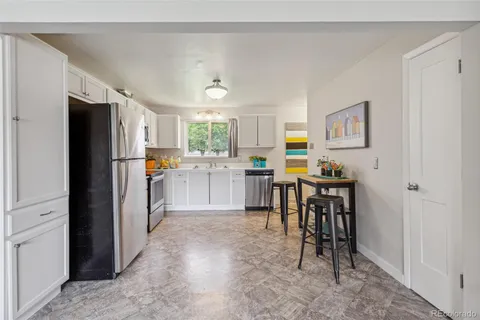 a kitchen view with stainless steel appliances a refrigerator and a stove top oven