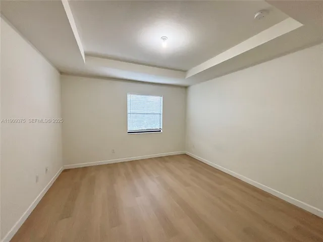 an empty room with a empty space and windows